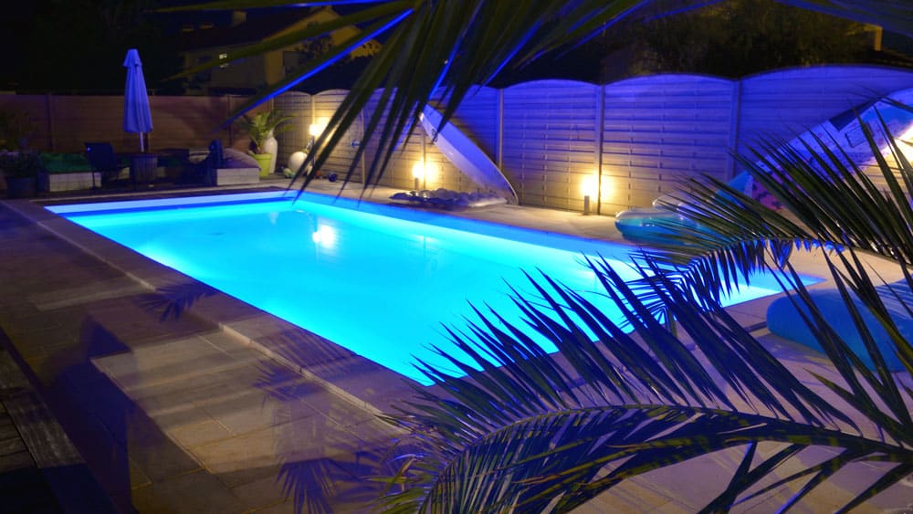 swimming pool at night with underwater lights on